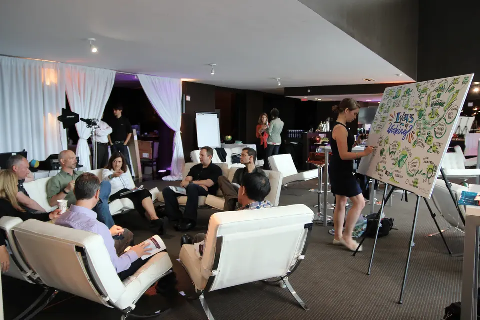 Audience members at a corporate town hall meeting engage with a presentation.